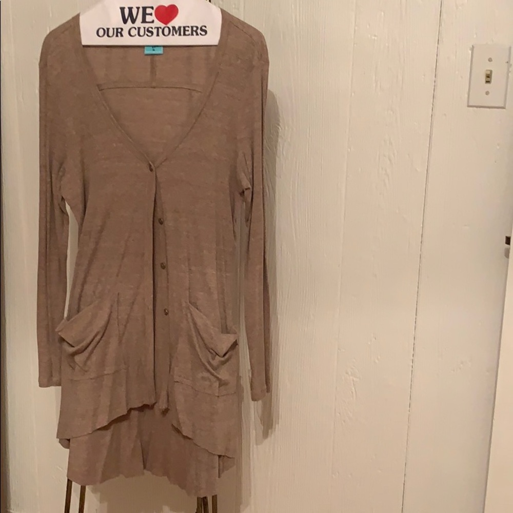 Thin buttoned down cardigan. Fits high-low.